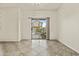 Bright living room with tile flooring and glass sliding doors leading to the backyard and outdoor spaces at 4712 E Amberwood Dr, Phoenix, AZ 85048
