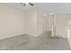 Bright living room boasts neutral walls and carpeting, with seamless access to the upper level and hallways at 4712 E Amberwood Dr, Phoenix, AZ 85048