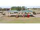 A colorful playground features slides and play structures with covered sunshades in a community park at 4712 E Amberwood Dr, Phoenix, AZ 85048