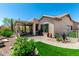 Beautiful backyard with covered patio, desert landscaping, and artificial grass at 5381 S Emerald Desert Dr, Gold Canyon, AZ 85118