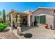Well-maintained backyard featuring a covered patio and attractive desert landscaping at 5381 S Emerald Desert Dr, Gold Canyon, AZ 85118