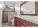 Bathroom featuring hardwood flooring, a granite vanity top and a tile shower at 5381 S Emerald Desert Dr, Gold Canyon, AZ 85118
