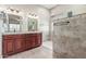 Spacious bathroom boasts dual vanities, a large mirror, and a beautifully tiled walk-in shower at 5381 S Emerald Desert Dr, Gold Canyon, AZ 85118