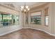 Bright dining area with hardwood floors, large windows, and a charming chandelier fixture at 5381 S Emerald Desert Dr, Gold Canyon, AZ 85118