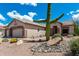 Beautiful desert landscaping with a large saguaro cactus in the front yard at 5381 S Emerald Desert Dr, Gold Canyon, AZ 85118