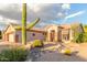 Charming single-story home with desert landscaping, featuring a large saguaro cactus and stone accents at 5381 S Emerald Desert Dr, Gold Canyon, AZ 85118