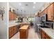 Spacious kitchen with stainless steel appliances, an island, and wood cabinets at 5381 S Emerald Desert Dr, Gold Canyon, AZ 85118