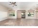 Open concept living room with wood floors, large windows, and sliding door to patio at 5381 S Emerald Desert Dr, Gold Canyon, AZ 85118
