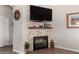 Inviting living room with a decorative tile fireplace and mounted TV at 5381 S Emerald Desert Dr, Gold Canyon, AZ 85118