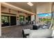 Expansive covered patio features comfortable seating, ceiling fans, and outdoor TV at 5381 S Emerald Desert Dr, Gold Canyon, AZ 85118