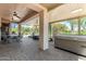 Spacious covered patio features multiple seating areas, ceiling fans, and hot tub at 5381 S Emerald Desert Dr, Gold Canyon, AZ 85118