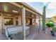 Outdoor covered patio has a built-in hot tub, desert landscaping, and ample natural light at 5381 S Emerald Desert Dr, Gold Canyon, AZ 85118