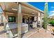 Covered patio featuring multiple seating arrangements, hot tub, and beautiful desert views at 5381 S Emerald Desert Dr, Gold Canyon, AZ 85118