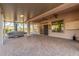 Expansive covered patio with ceiling fans, tiled flooring, and hot tub hookups at 5381 S Emerald Desert Dr, Gold Canyon, AZ 85118