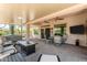 Relaxing covered patio with hot tub, TV, and comfortable seating area at 5381 S Emerald Desert Dr, Gold Canyon, AZ 85118
