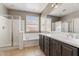 Bright bathroom with double sink vanity, bathtub, and a separate glass shower at 5408 W Allen St, Laveen, AZ 85339