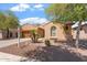 Charming single-story home featuring a two-car garage, desert landscaping, and an arched entry at 5408 W Allen St, Laveen, AZ 85339