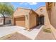 Charming single-story home featuring a two-car garage and an arched entry at 5408 W Allen St, Laveen, AZ 85339