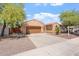 Charming single-story home featuring a two-car garage and desert landscaping at 5408 W Allen St, Laveen, AZ 85339