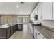 Open-concept kitchen with stainless steel appliances and a peninsula overlooking the breakfast room at 5408 W Allen St, Laveen, AZ 85339