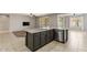 Kitchen island with stainless sink and dishwasher overlooking the great room with luxury vinyl flooring at 5408 W Allen St, Laveen, AZ 85339