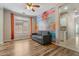Bright living room with graffiti brick wall, wood-look floors, and abundant natural light at 5408 W Allen St, Laveen, AZ 85339