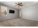 Main bedroom featuring neutral carpet and a window with natural light at 5408 W Allen St, Laveen, AZ 85339