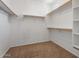 Walk-in closet with shelves, hanging rods, and carpeting at 5408 W Allen St, Laveen, AZ 85339
