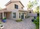 Spacious backyard with a covered patio, brick pavers, and lush greenery at 8863 S Grandview Dr, Tempe, AZ 85284