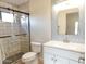 Modern bathroom with walk-in shower, vanity with sink, mirror, and neutral color scheme at 8863 S Grandview Dr, Tempe, AZ 85284