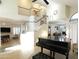 Spacious living room featuring high ceilings, elegant staircase, and grand piano at 8863 S Grandview Dr, Tempe, AZ 85284