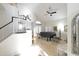 Bright living area with tiled floors, staircase, modern fan, and piano at 8863 S Grandview Dr, Tempe, AZ 85284