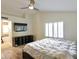 Main bedroom with a bed, ceiling fan, and shutters overlooking a bathroom at 8863 S Grandview Dr, Tempe, AZ 85284