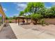 Expansive backyard featuring a wooden gazebo, concrete patio, and desert landscaping, perfect for outdoor living at 9154 E Caribbean Ln, Scottsdale, AZ 85260