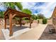 Inviting backyard featuring a charming wooden gazebo with concrete pavers and lush landscaping at 9154 E Caribbean Ln, Scottsdale, AZ 85260