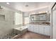 Bright bathroom features a double sink vanity, separate tub and glass enclosed walk-in shower at 9154 E Caribbean Ln, Scottsdale, AZ 85260