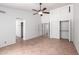 Expansive bedroom with ceiling fan, walk-in closets, and access to other rooms at 9154 E Caribbean Ln, Scottsdale, AZ 85260