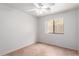 Bright bedroom with tile floors, a ceiling fan, and a window with blinds at 9154 E Caribbean Ln, Scottsdale, AZ 85260