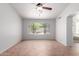 Large bedroom with a view to the backyard, ceiling fan, and tile flooring at 9154 E Caribbean Ln, Scottsdale, AZ 85260