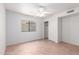 A bright bedroom featuring tile floors, a ceiling fan, and a window with vertical blinds at 9154 E Caribbean Ln, Scottsdale, AZ 85260