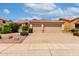 Charming home featuring a tile roof and a spacious three-car garage, complemented by lush landscaping at 9154 E Caribbean Ln, Scottsdale, AZ 85260