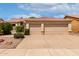 Charming home featuring a tile roof and a spacious three-car garage, complemented by lush landscaping at 9154 E Caribbean Ln, Scottsdale, AZ 85260