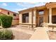 Inviting front entrance with desert landscaping, a decorative security door, and charming architectural details at 9154 E Caribbean Ln, Scottsdale, AZ 85260