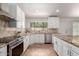 Charming kitchen with granite countertops, stainless steel appliances, and a stylish backsplash at 9154 E Caribbean Ln, Scottsdale, AZ 85260