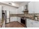 Bright kitchen features granite countertops, stainless steel appliances, and modern cabinetry at 9154 E Caribbean Ln, Scottsdale, AZ 85260