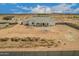 An aerial view of a new white home with a covered patio and desert landscaping at 9486 W Sandstone Mountain Dr, Casa Grande, AZ 85194