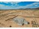 An aerial shot shows a large desert lot with the home and perimeter fence in a desert community at 9486 W Sandstone Mountain Dr, Casa Grande, AZ 85194
