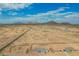 Wide aerial view highlighting desert homes near mountains with the open desert and roads visible at 9486 W Sandstone Mountain Dr, Casa Grande, AZ 85194