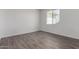 Bright bedroom with wood-look floors and ample natural light from the window at 9486 W Sandstone Mountain Dr, Casa Grande, AZ 85194
