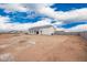 The rear exterior of a white home and covered patio with construction materials nearby at 9486 W Sandstone Mountain Dr, Casa Grande, AZ 85194